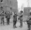 German prisoners being searched by 53rd (Welsh) Division troops in Alpen, 11 March 1945.jpg