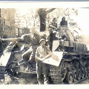 Chick (standing), Doug James (draped on gun barrel) plus two other 2742 airmen on a dead tank