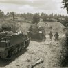 Universal carriers, infantry and Sherman tanks move forward 30 July 1944.jpg