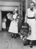 Nurses_carry_babies_during_a_gas_drill_in_a_London_hospital_during_1940._D654.jpg