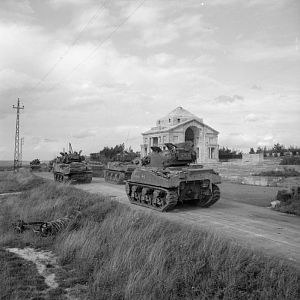 Sherman tanks of Guards Armoured Division pass British First World War memorial at Fouilloy, advance towards Arras, 1 September 1944; IWM BU 271